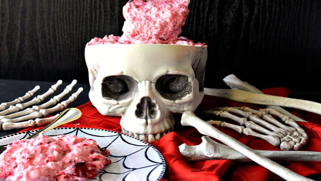 Spooning out the brains of a skull filled with brain food jello salad.