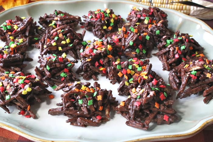 A colorful plate of sweet and salty chocolate haystack candy with autumn leave sprinkles.