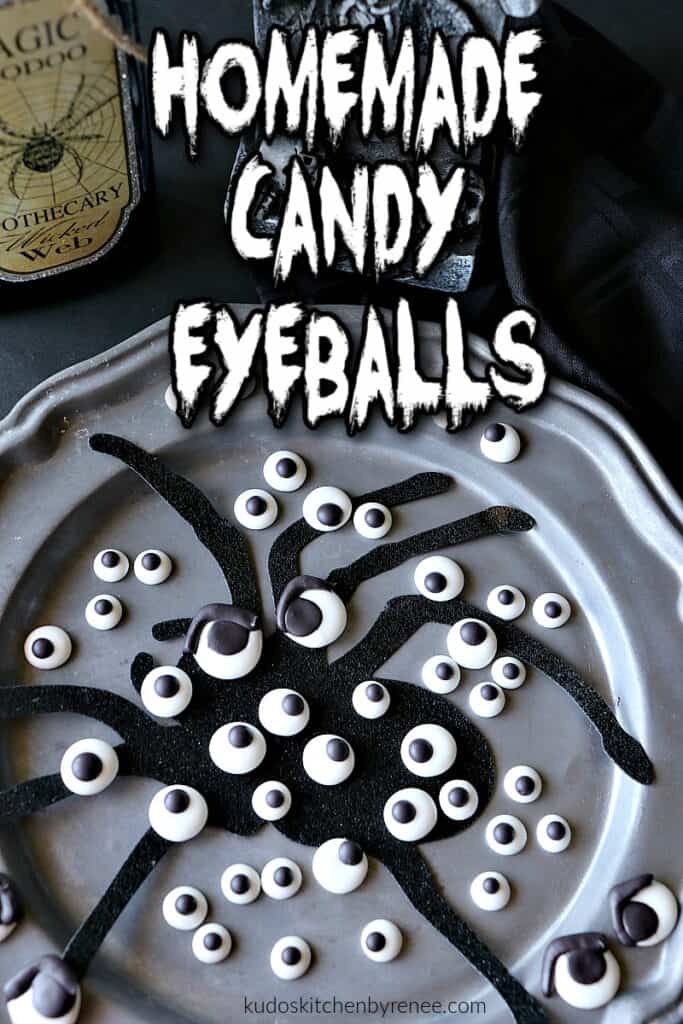 A vertical closeup photo of a bunch of Homemade Candy Eyeballs on a pewter plate with a scary looking title text overlay graphic.