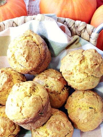 A basket of Pumpkin Sage Biscuits with pumpkins in the background.