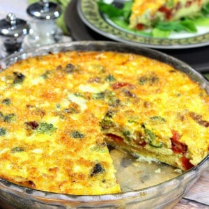 A Spaghetti Squash Quiche in a pie plate with a slice taken out.