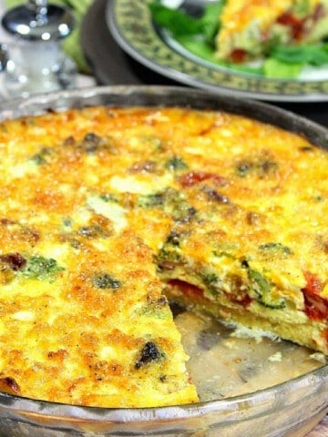 A Spaghetti Squash Quiche in a pie plate with a slice taken out.