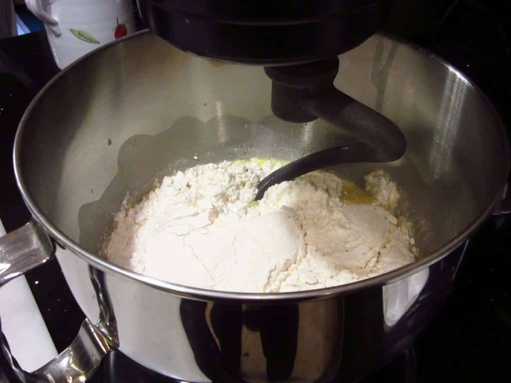 A dough hook in a mixing bowl.