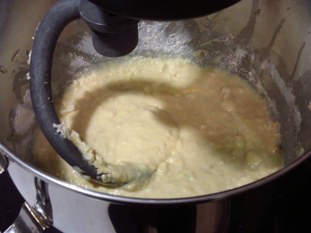 A stand mixer mixing dough.