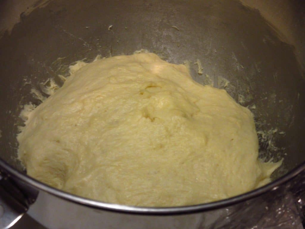 Proofed batter bread dough in a mixing bowl.
