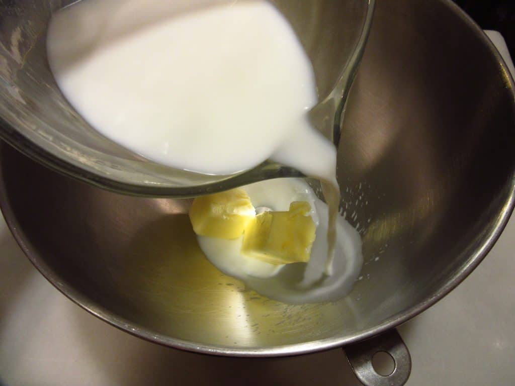 Milk being added to a mixing bowl.