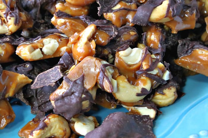 Closeup photo of butter toffee cashew crunch candy with chocolate drizzle.