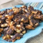 A blue plate loaded with Butter Toffee Cashew Crunch.