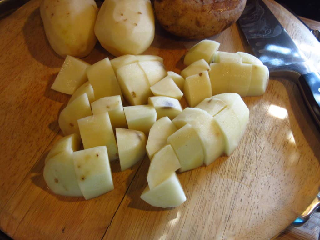 Chopped potatoes on a cutting board.