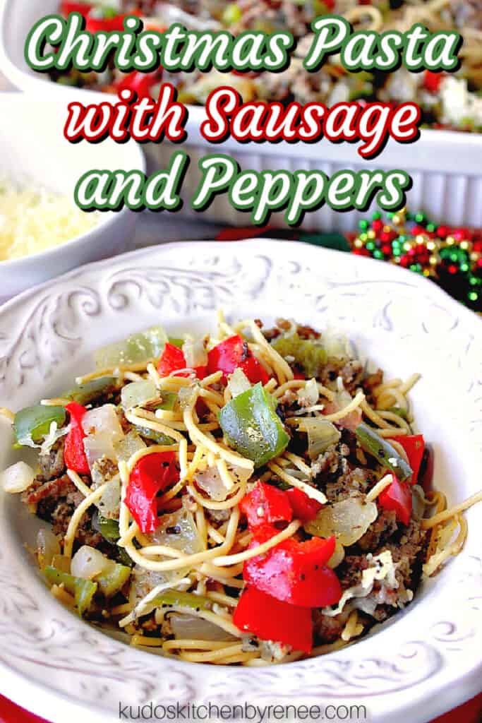 A vertical closeup of a pretty white bowl filled with Christmas Pasta with Sausage, Onion, and Peppers with a title text overlay graphic in red, white, and green