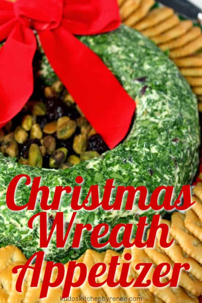  Vertical title text closeup image of Christmas wreath appetizer with parsley, pistachios, crackers and a red bow.