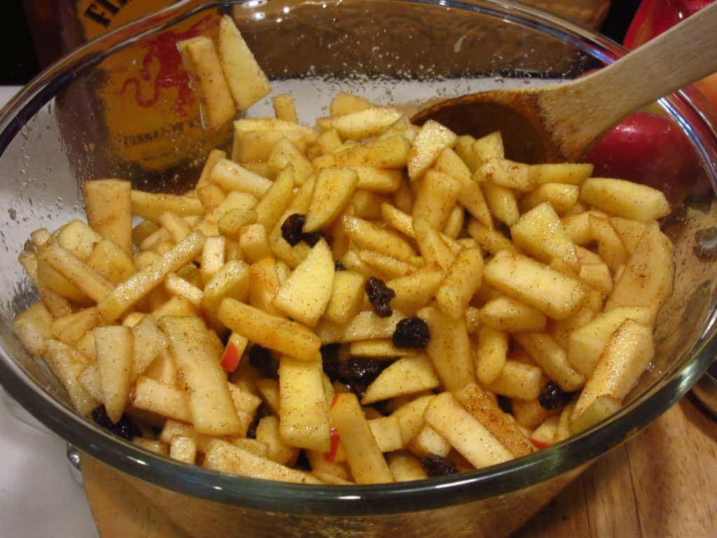 A bowl of diced apples with spices.