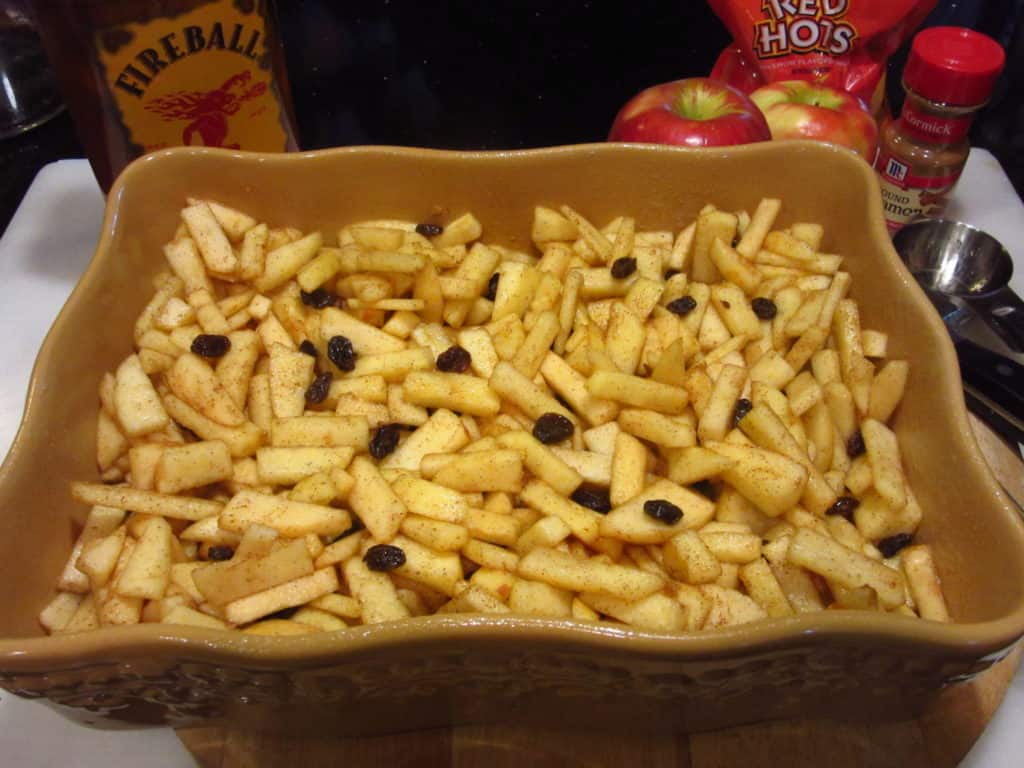 Diced and seasoned apples in a baking dish.