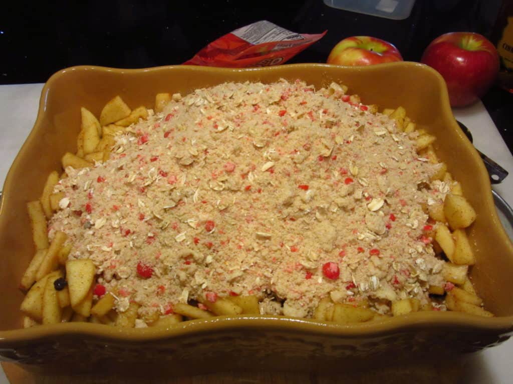 A topping over the top of diced apples in a dish.