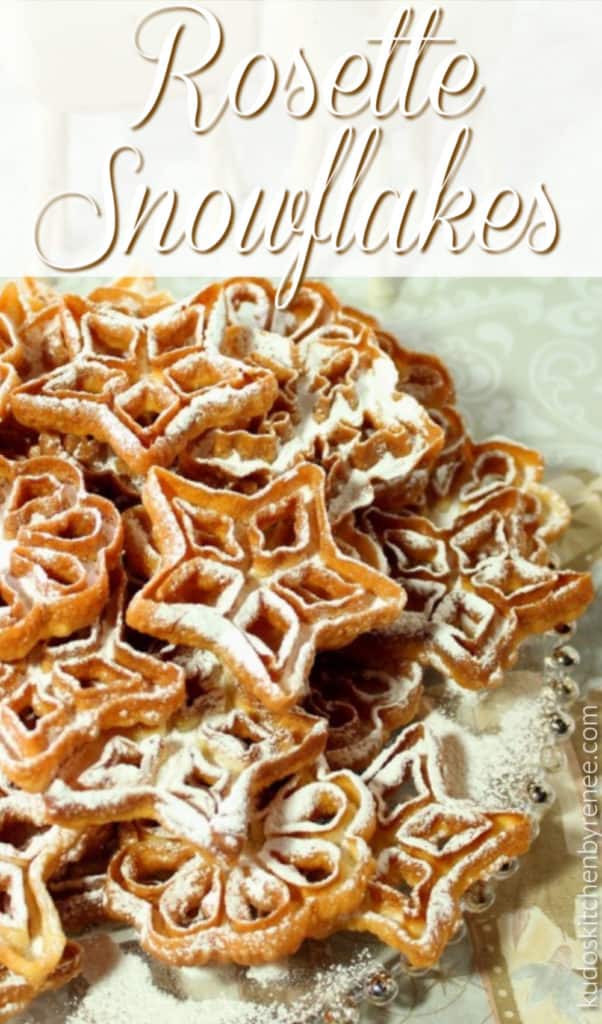 A vertical closeup image of a platter of fried rosette snowflakes with confectioners sugar and a title text overlay graphic