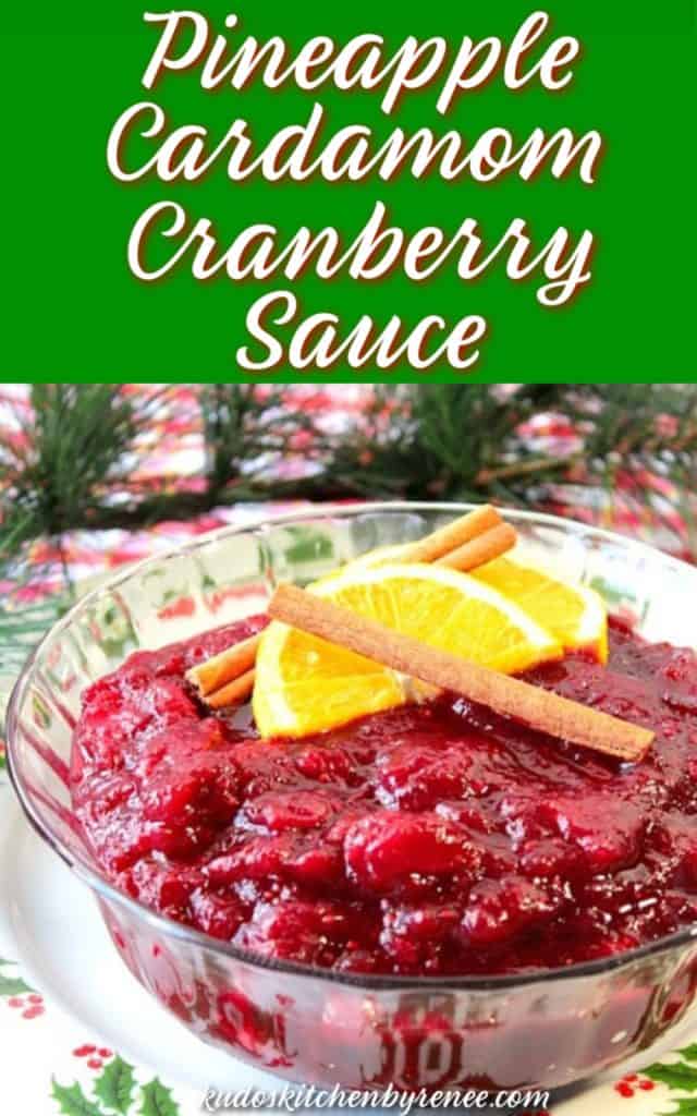 Vertical title text image of pineapple cardamom cranberry sauce in a glass bowl with cinnamon sticks and orange slices.