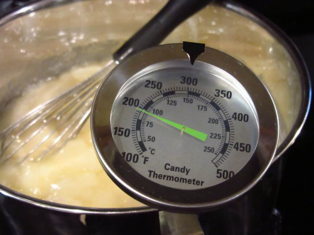 A candy thermometer in a saucepan.