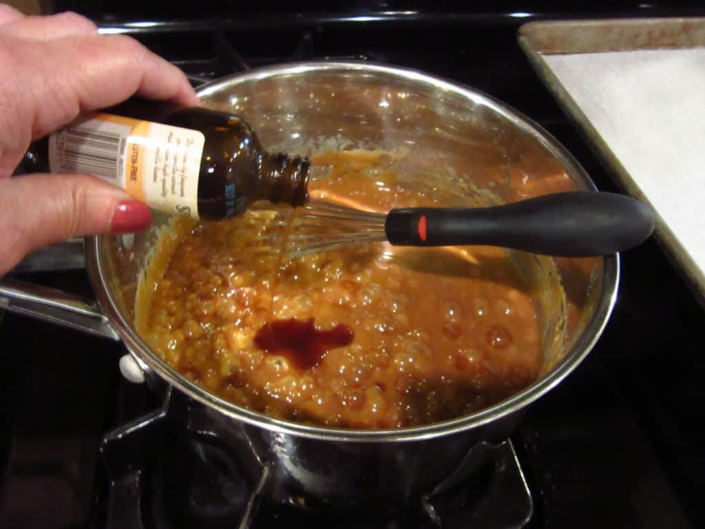 Vanilla being added to a saucepan.