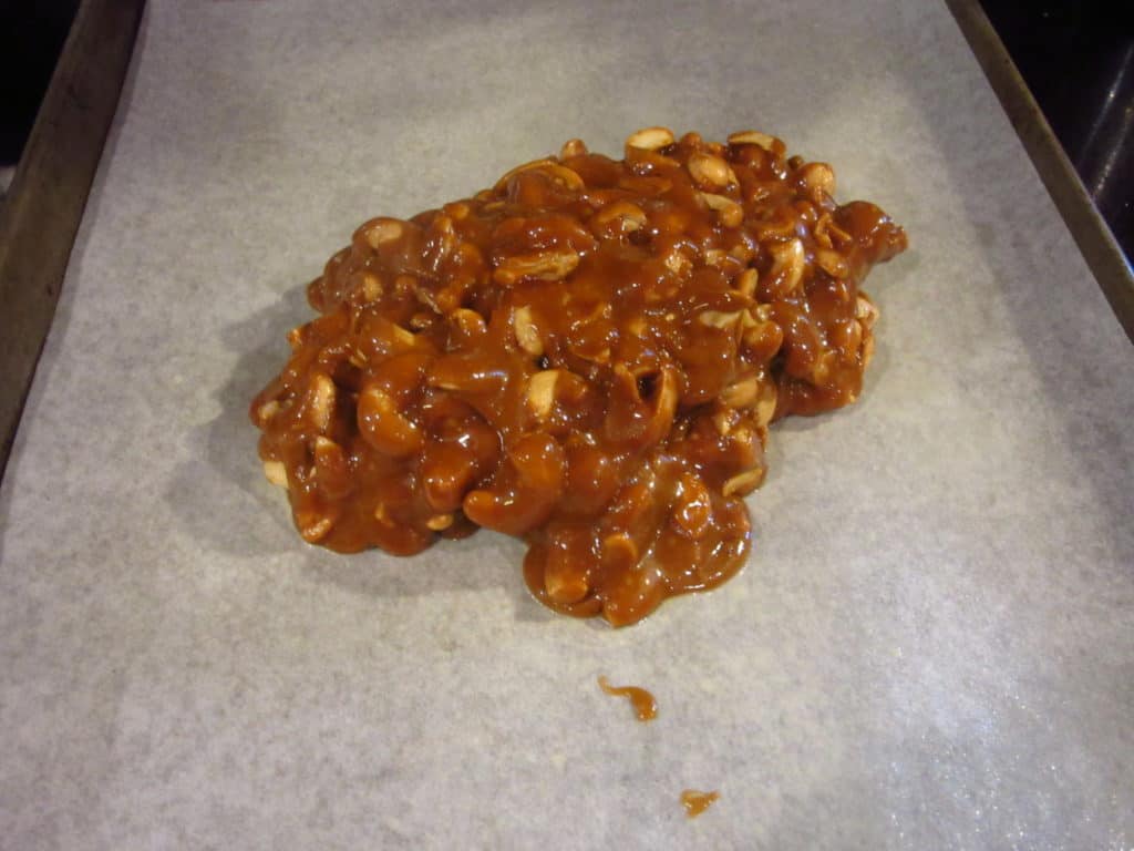 Cashew toffee on a parchment sheet.