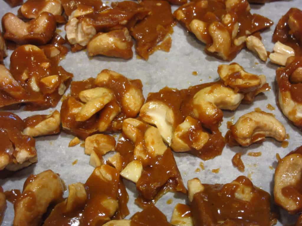 Broken Cashew Toffee on a baking sheet.