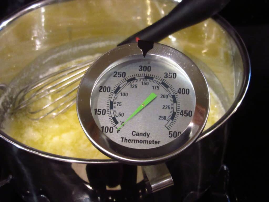 A candy thermometer in a saucepan.