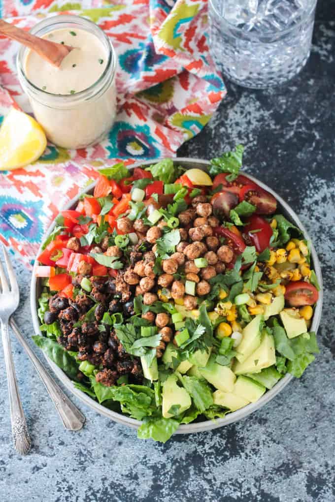Chickpea taco salad with tomatoes, corn, beans, and greens. Healthy salad recipe roundup.