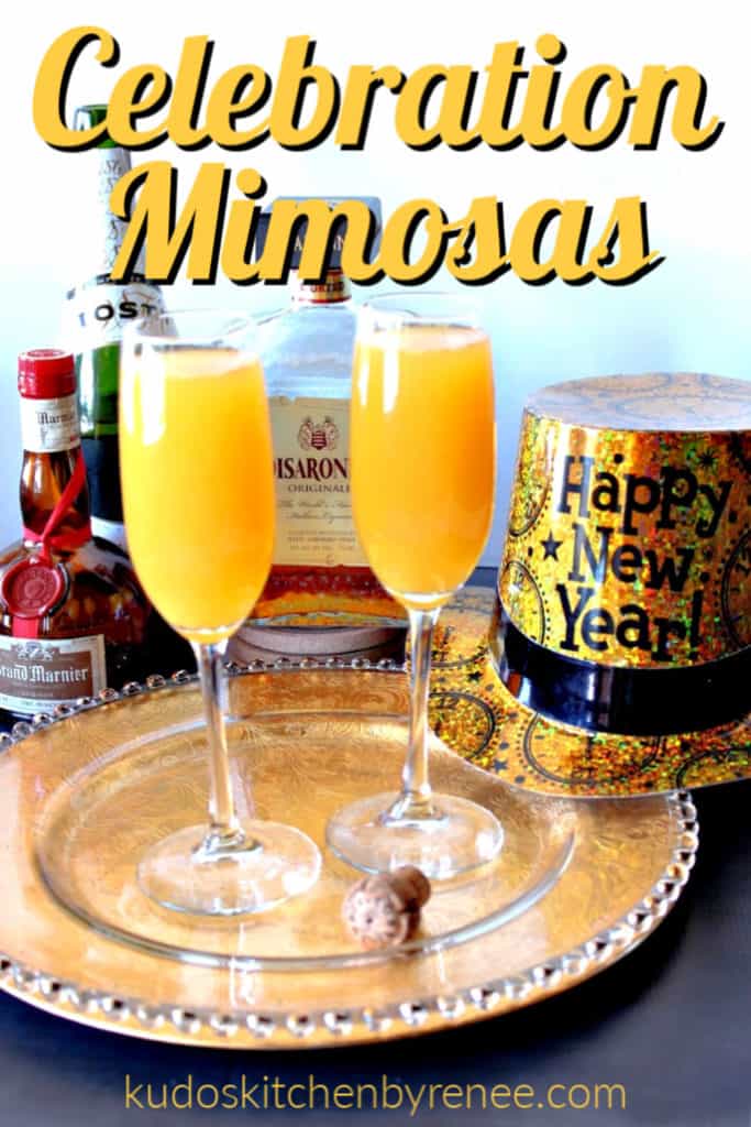 A vertical title text image of two mimosas on a decorative tray with a wine cork, a new years hat, and alcohol bottles in the background.