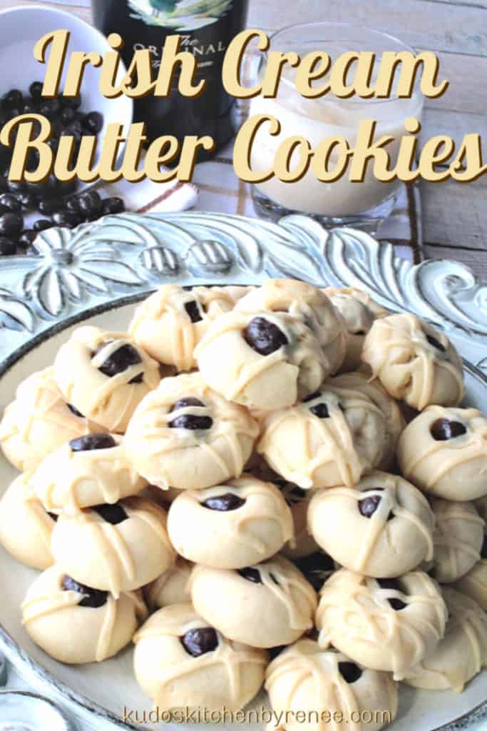 Vertical title text closeup image of Irish Cream Butter Cookies on a pretty plate with a dish of chocolate-covered espresso beans, and a glass of Irish cream liquor in the background.