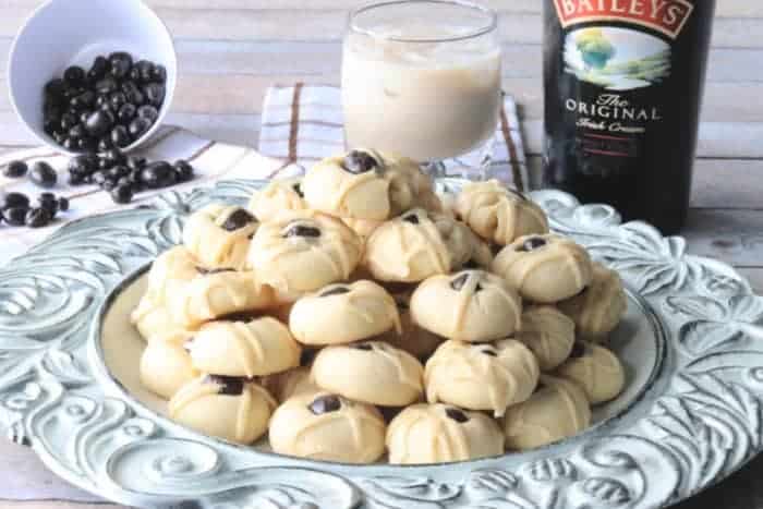 A decorative round plate filled with Irish cream butter cookies with chocolate covered espresso beans