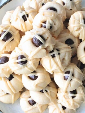 A stack of Irish Cream Butter Cookies with Irish cream Glaze and a chocolate espresso bean on top.