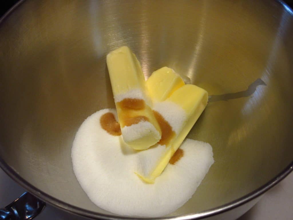 Butter, sugar, and vanilla extract in a bowl.