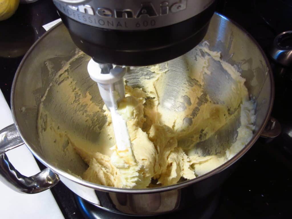 Cookie batter in a stand mixer with the paddle attachment.