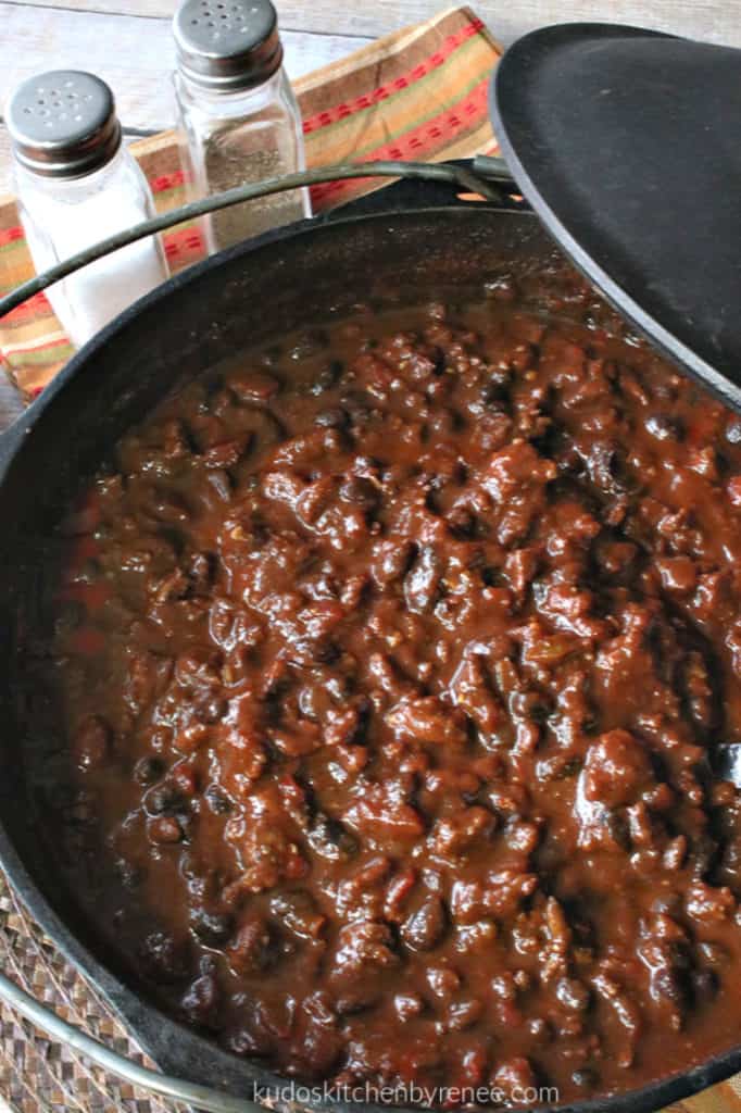 An overhead vertical photo looking inside cast iron a pot of deep, rich, mole turkey chili.