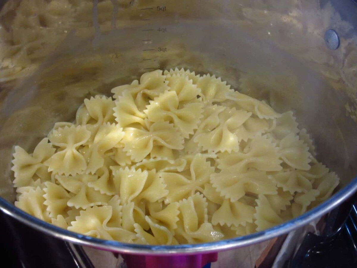 Cooked bow tie pasta in a pan.