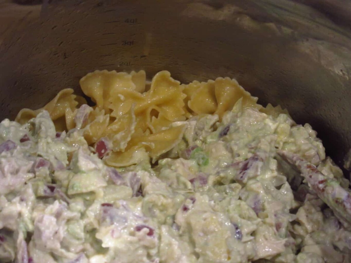 Cooked bow tie pasta in a creamy chicken avocado sauce.
