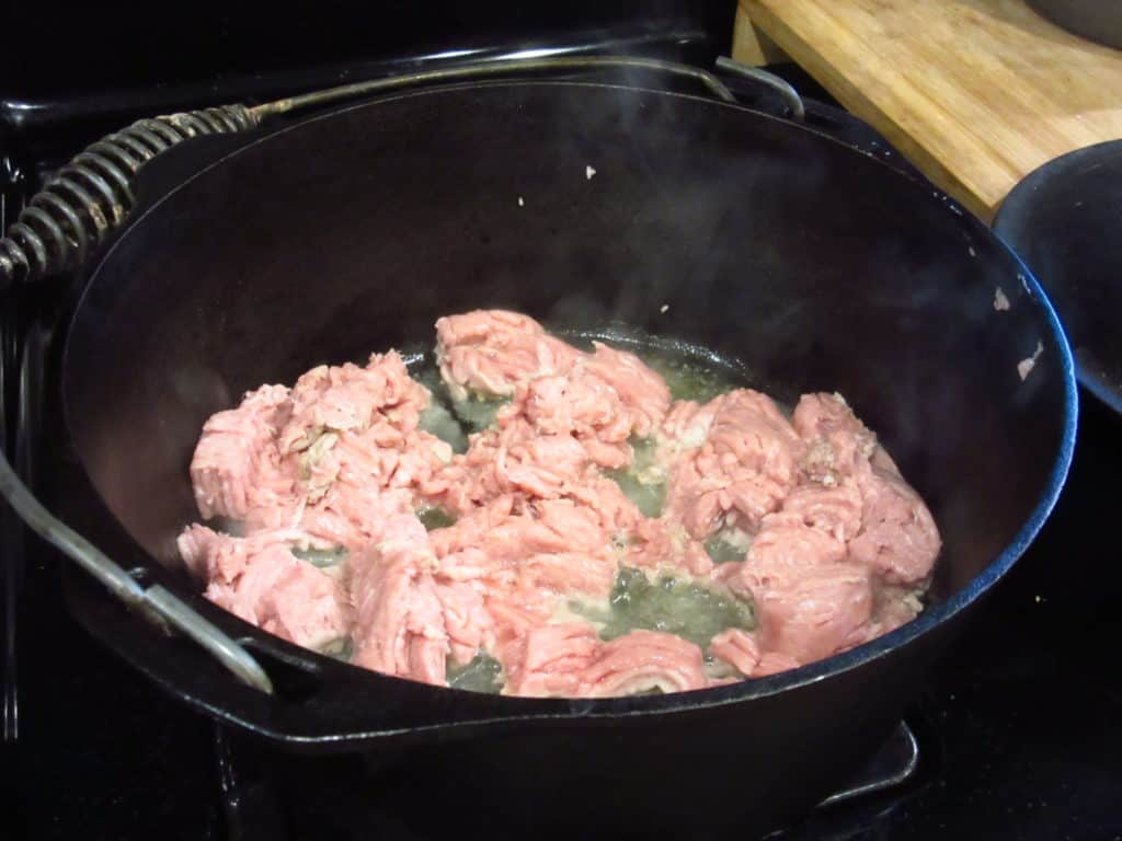 Ground turkey in a cast iron Dutch oven.