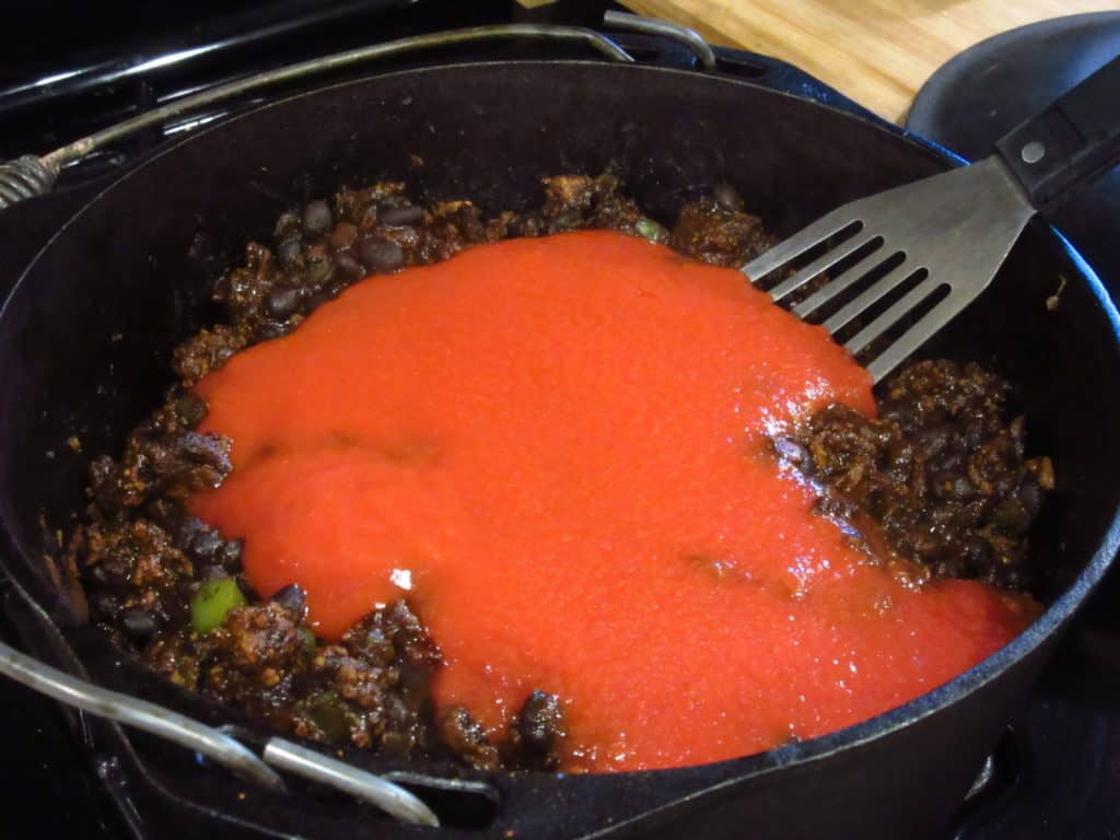 Tomato sauce in a pot of mole chili.