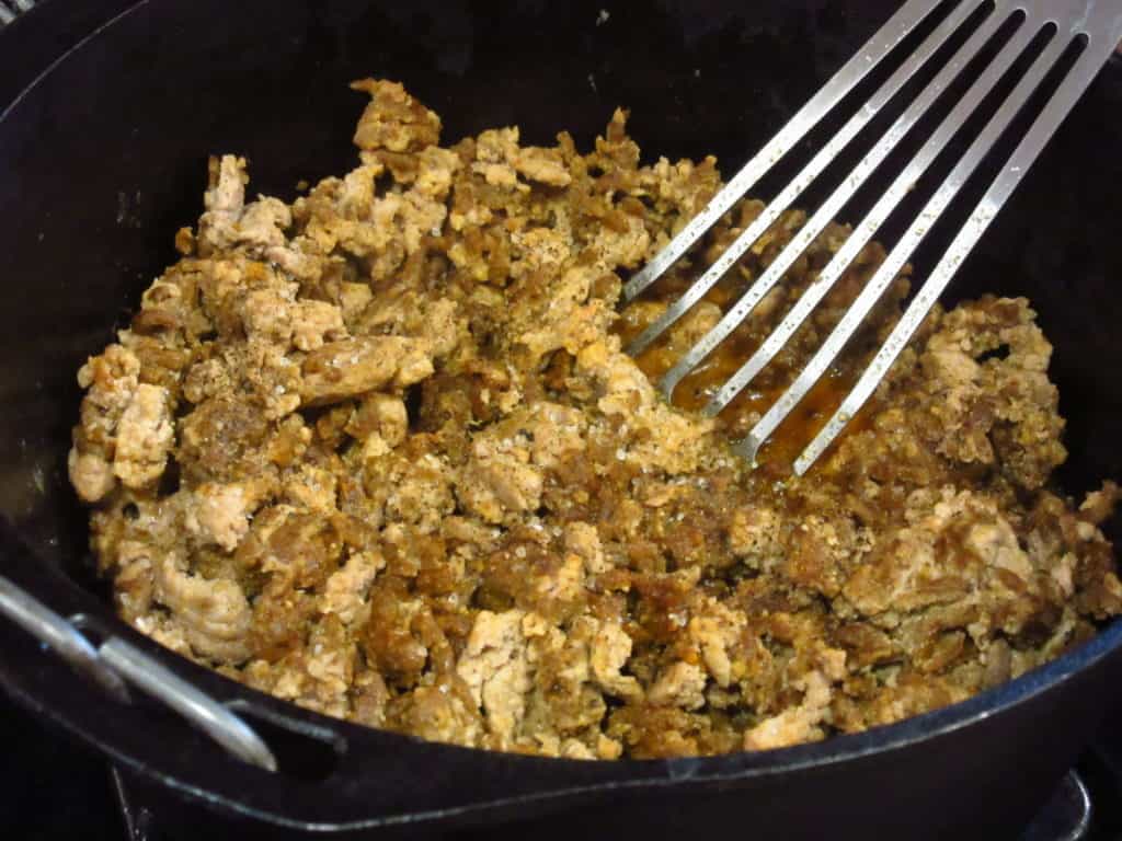 Browned ground turkey in a Dutch oven.