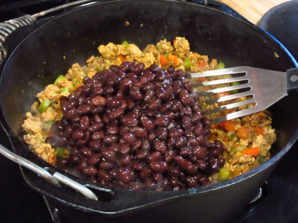 Black beans in a big pot of chili.