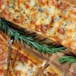 An overhead closeup of cheesy Roasted Garlic Bread with Rosemary