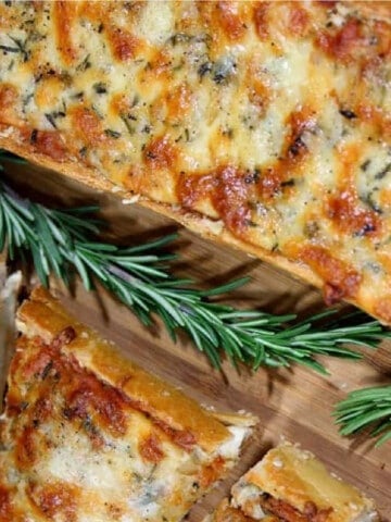 An overhead closeup of cheesy Roasted Garlic Bread with Rosemary