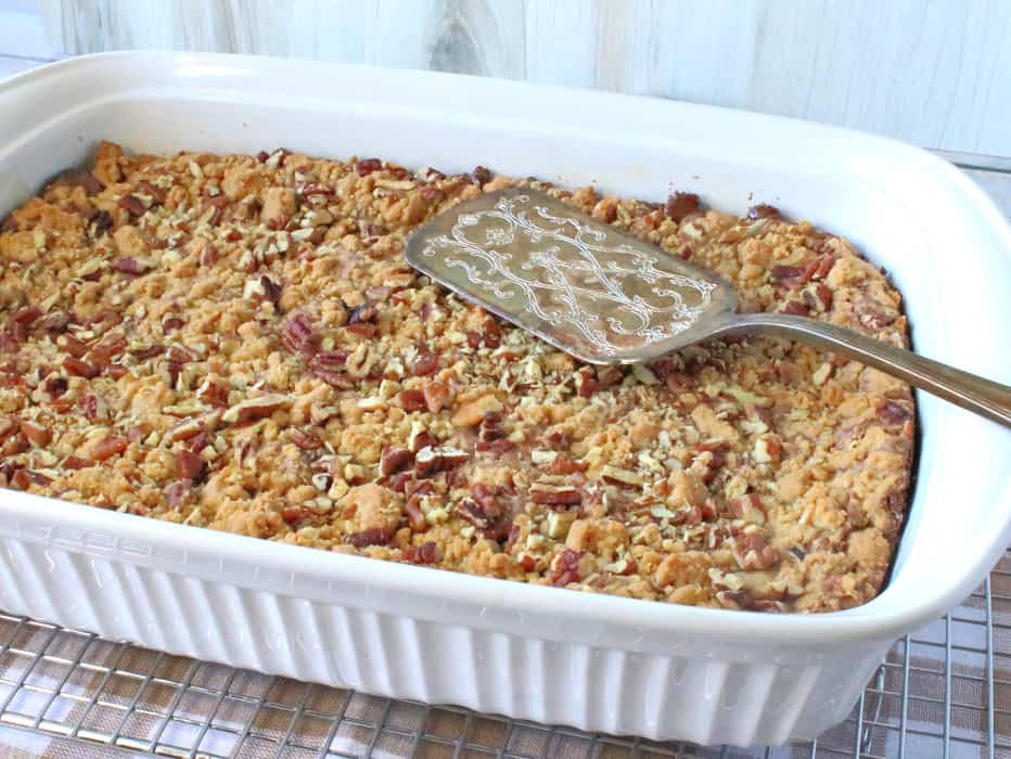 A horizontal photo os a 9x13 pan filled with hazelnut spread cookie bars with a serving utensil on the top.