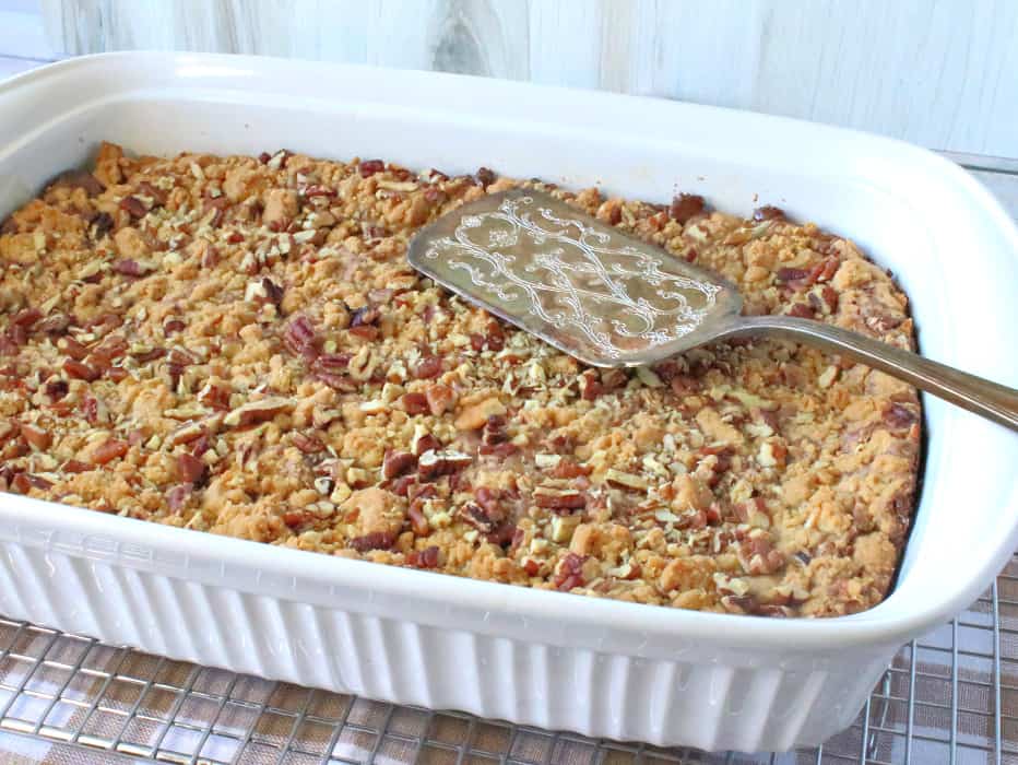 A horizontal photo os a 9x13 pan filled with hazelnut spread cookie bars with a serving utensil on the top.