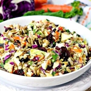 A white bowl filled with a colorful Sunflower Crunch Salad.