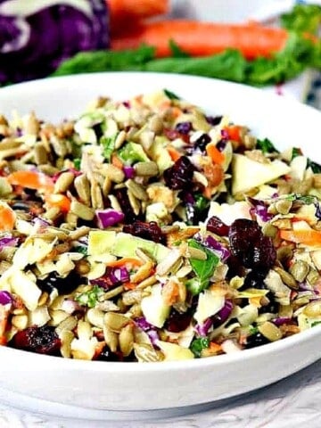 A white bowl filled with a colorful Sunflower Crunch Salad.