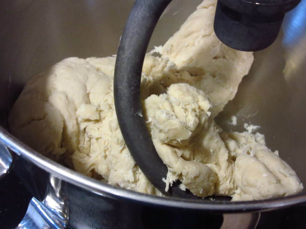 Dough hook mixing dough.