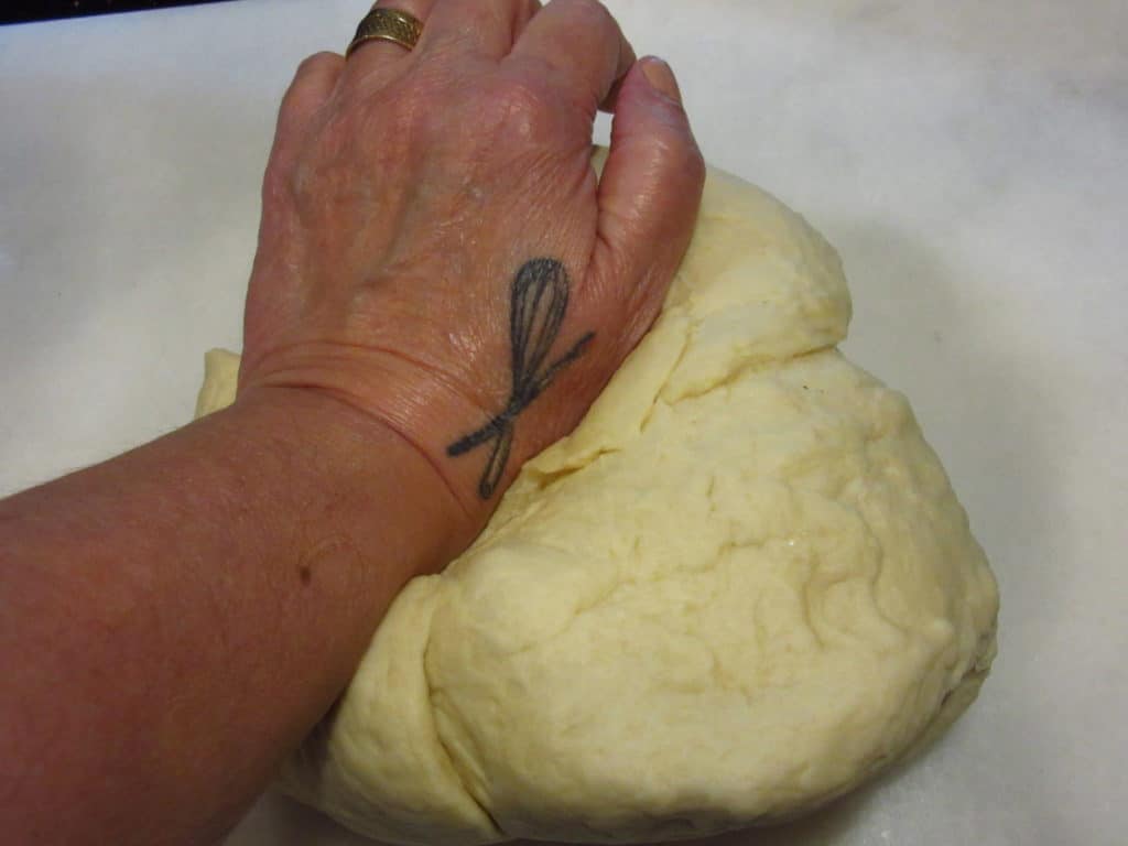 Hand kneading dough.