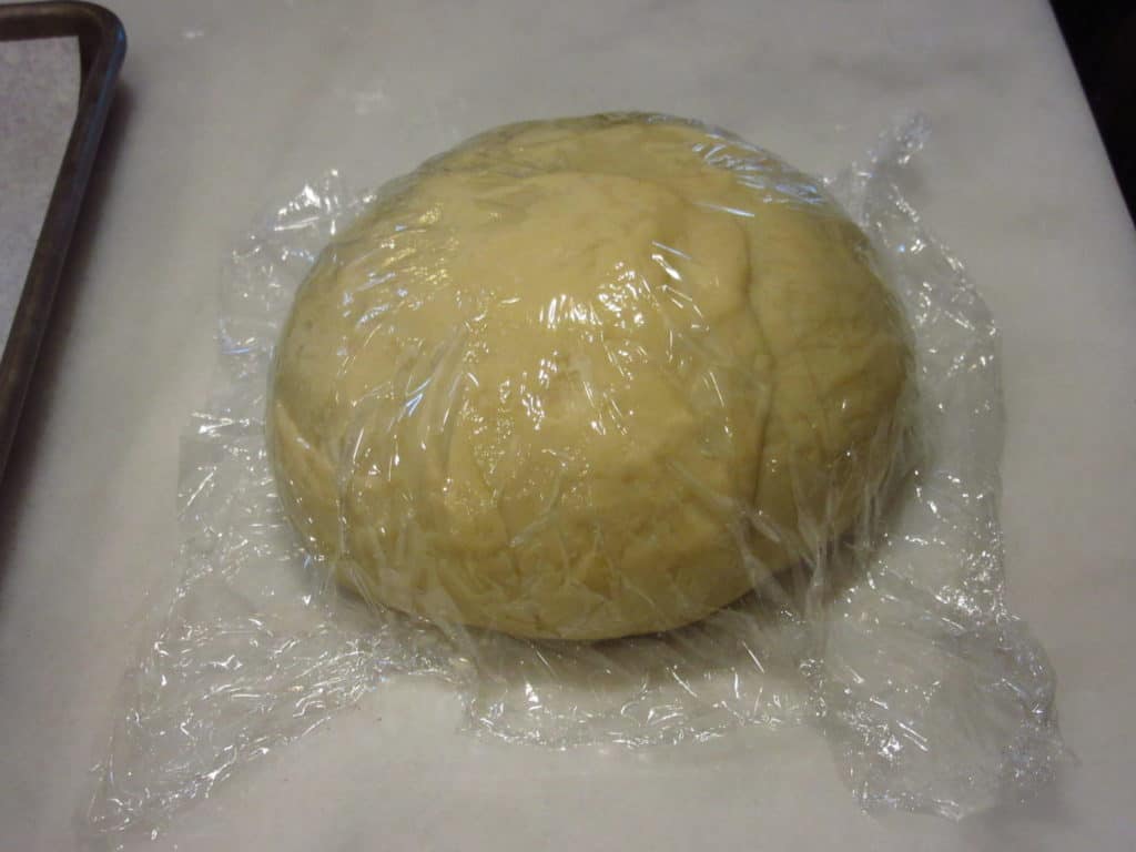Dough covered with plastic wrap.
