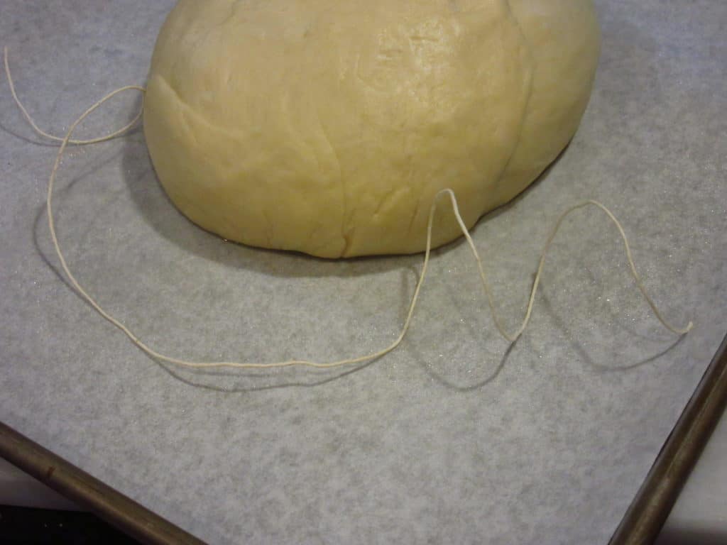 Twine and dough on a counter.