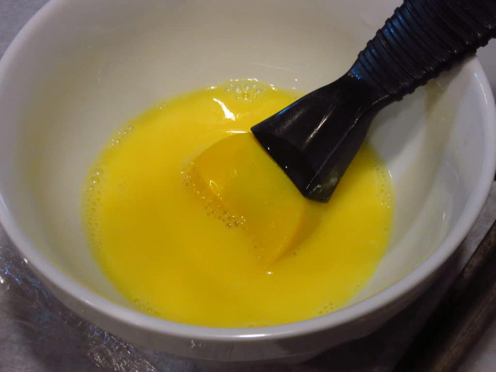 Egg wash with a brush.